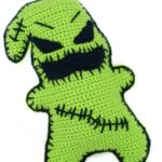 Crocheted green monster with stitches across it's chest